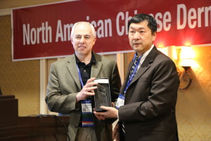 NACDA president, Kehua Li, M.D. presented a plaque to Dirk Elston, M.D. in recognizing his effort to improve dermatologist exchange cross pacific.
